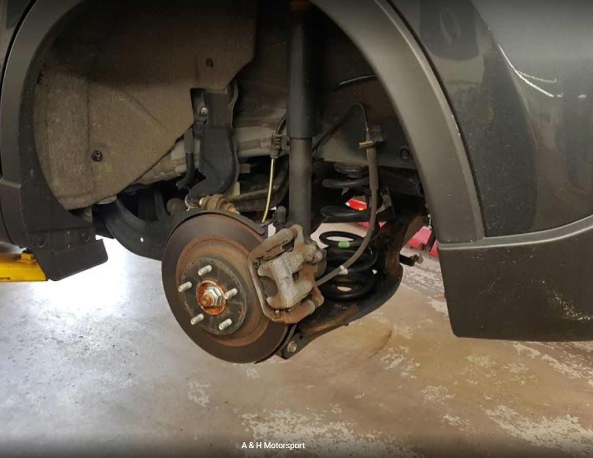 Car wheel undergoing repair or maintenance, showing attention to the vehicle's wheels